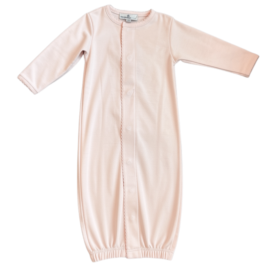 A pink long-sleeve baby gown with a snap-button front closure