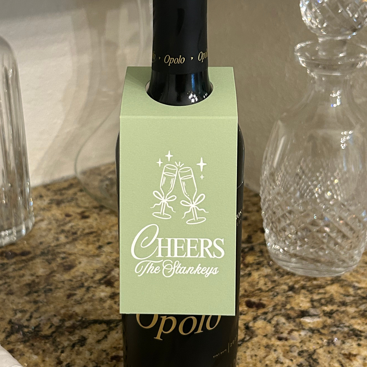 Personalized green wine gift tag with "cheers" and your family name