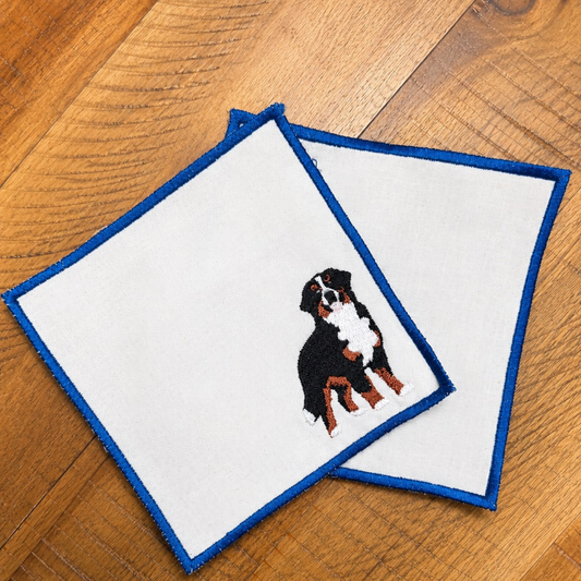 Set of linen napkins with  dog illustrations and a blue border
