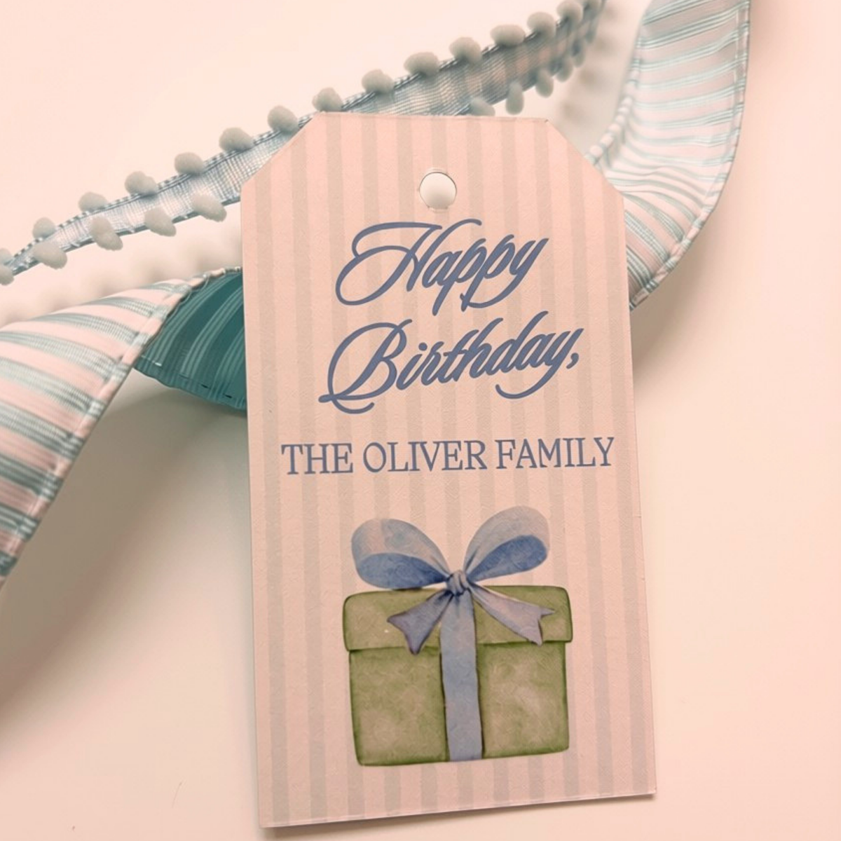 Birthday gift tag with blue stripes and watercolor style gift personalized with family name 