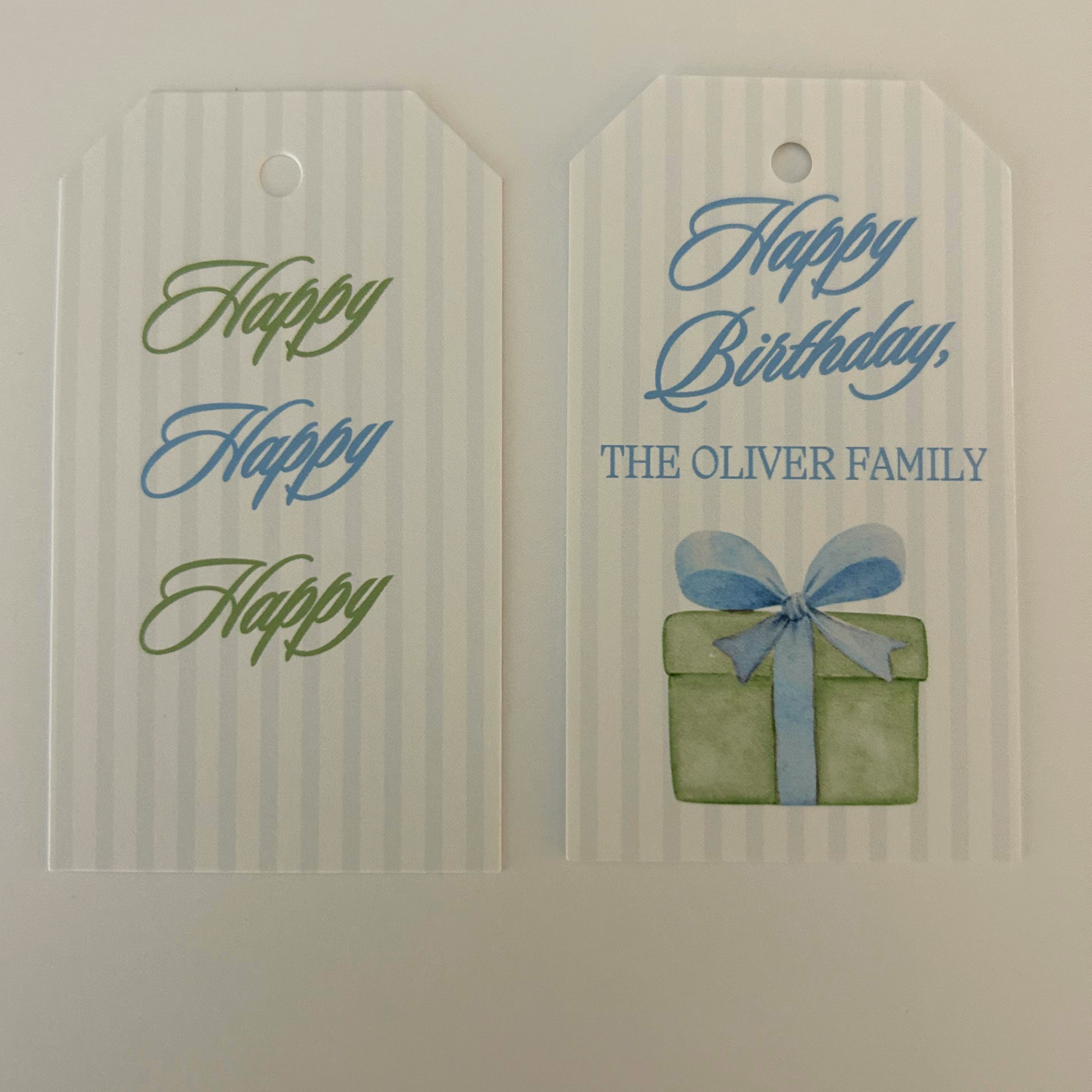 Personalized birthday tags with a white and light blue stripe pattern with green and light blue script and a watercolor style gift