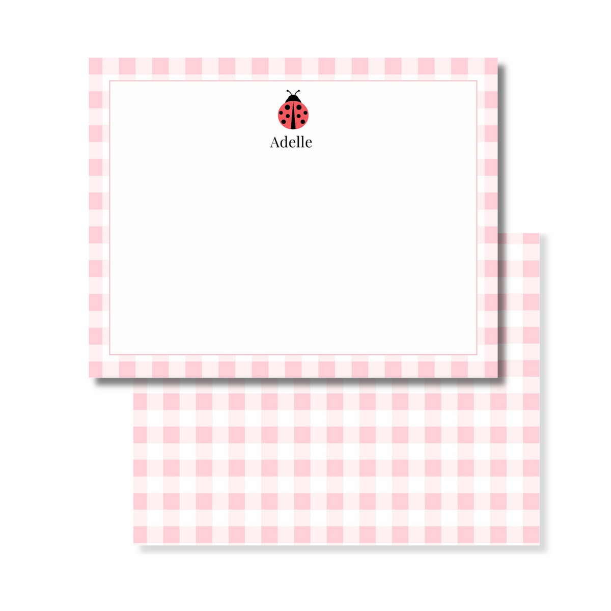 A personalized stationery set featuring a pink and white gingham checkered card. The top card is personalized with a small red ladybug icon and the name printed in black.