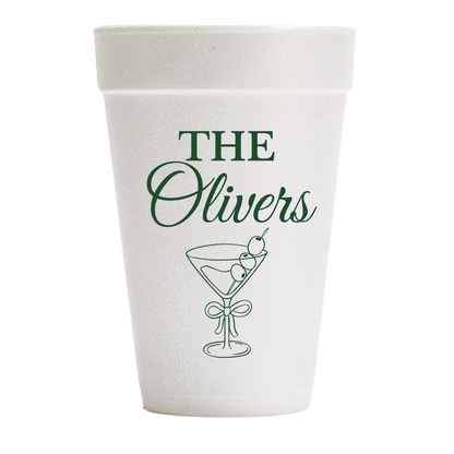A white foam cup with green printed text  and a martini glass 