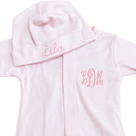 light pink baby gown and matching hat set with pink embroidered monogram lettering 