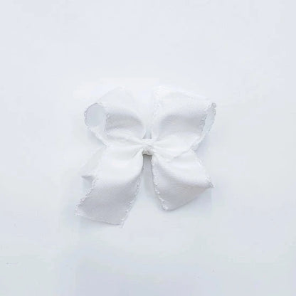 white fabric hair bow with white trim