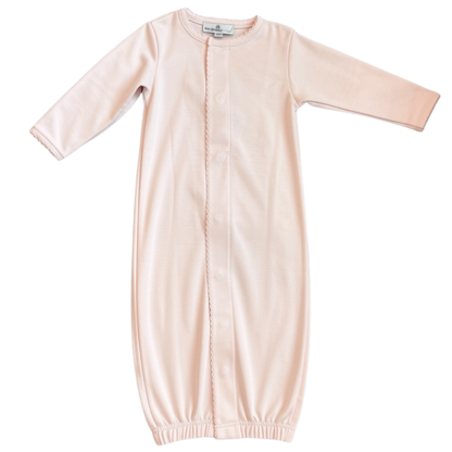 A pink long-sleeve baby gown with a snap-button front closure