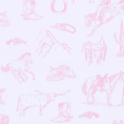 A close-up of a white fabric with a light pink western-themed toile pattern featuring horses, boots, hats, mountains, and a cowboy rifle.